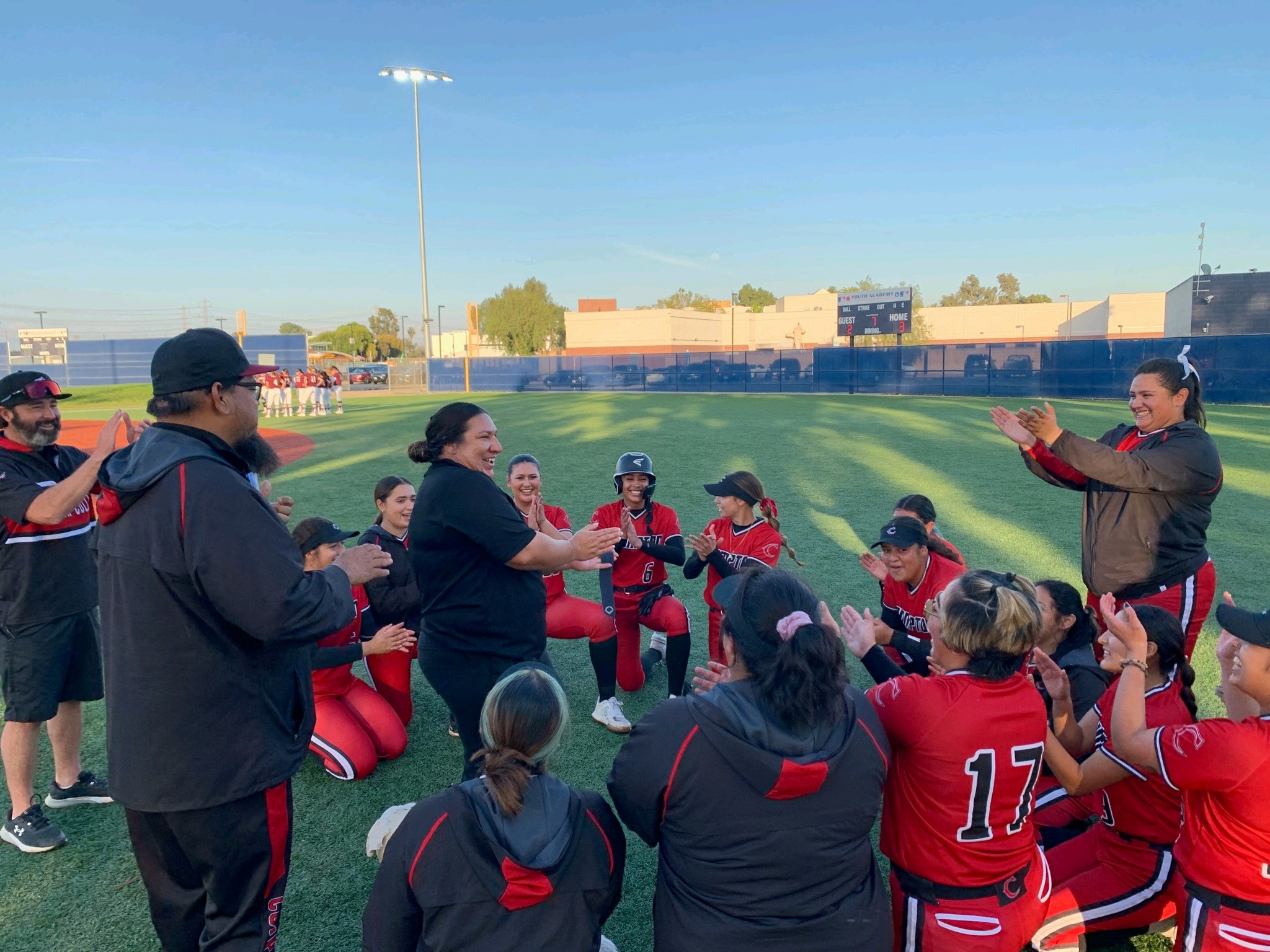 Coach Castillo and Compton softball team all smiles after the program's historic win.
